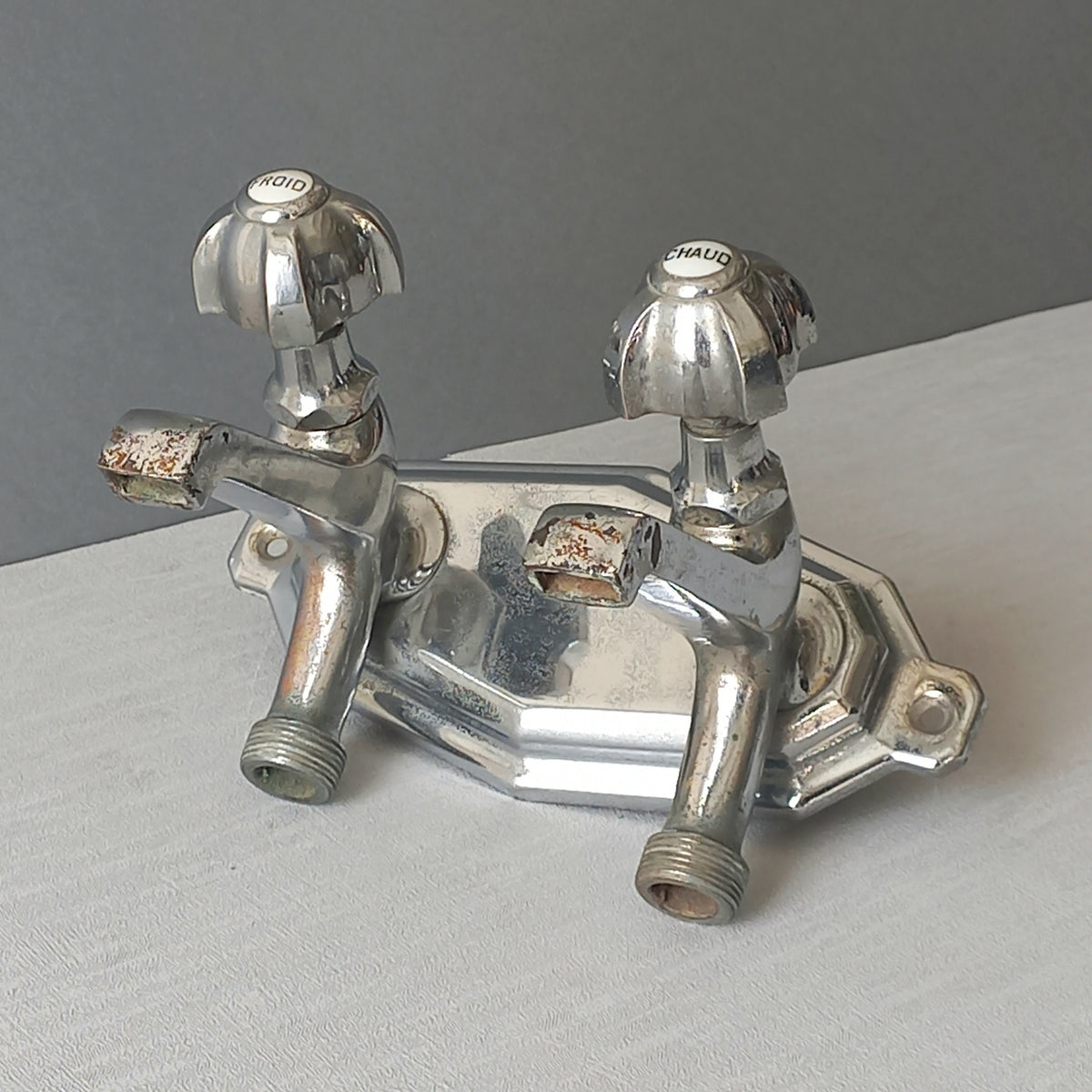 Stylish French vintage hot and cold faucet taps that are heavy, quality pieces probably dating from the 1930s time-frame. These old taps are being sold only as a restoration piece or project.