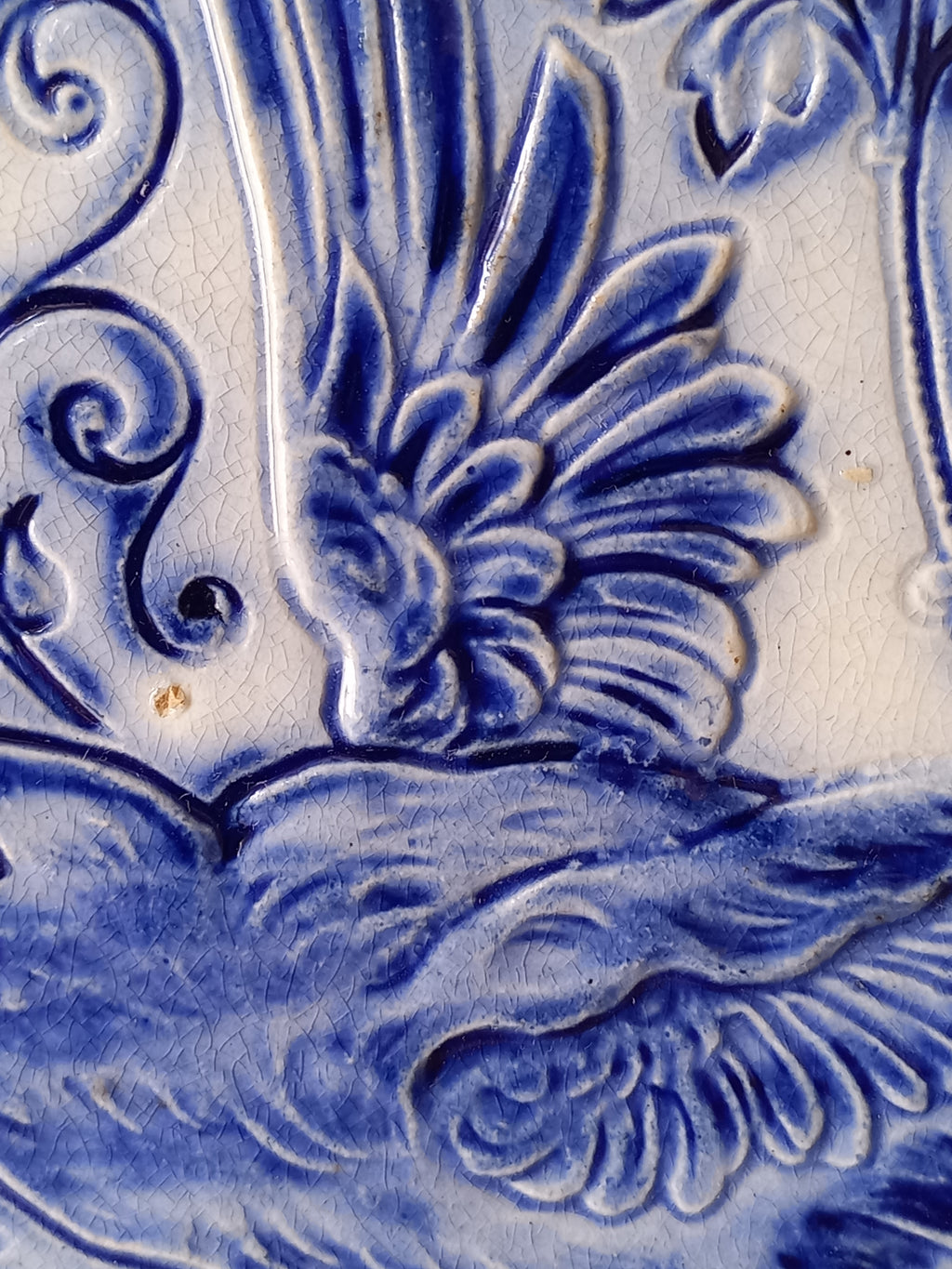 Close-up view of antique decorative majolica plate by premier Belgian manufacture, Wasmuel.