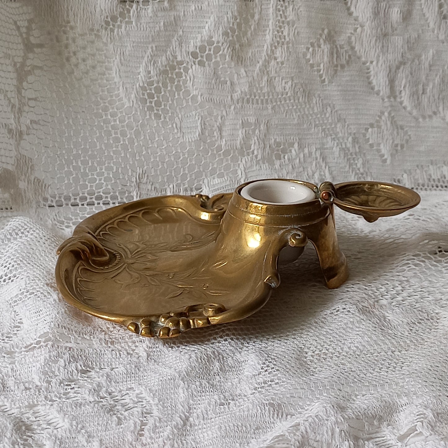 Decorative vintage brass inkwell with white porcelain ink cup