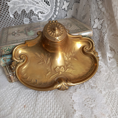 Decorative vintage brass inkwell with white porcelain ink cup