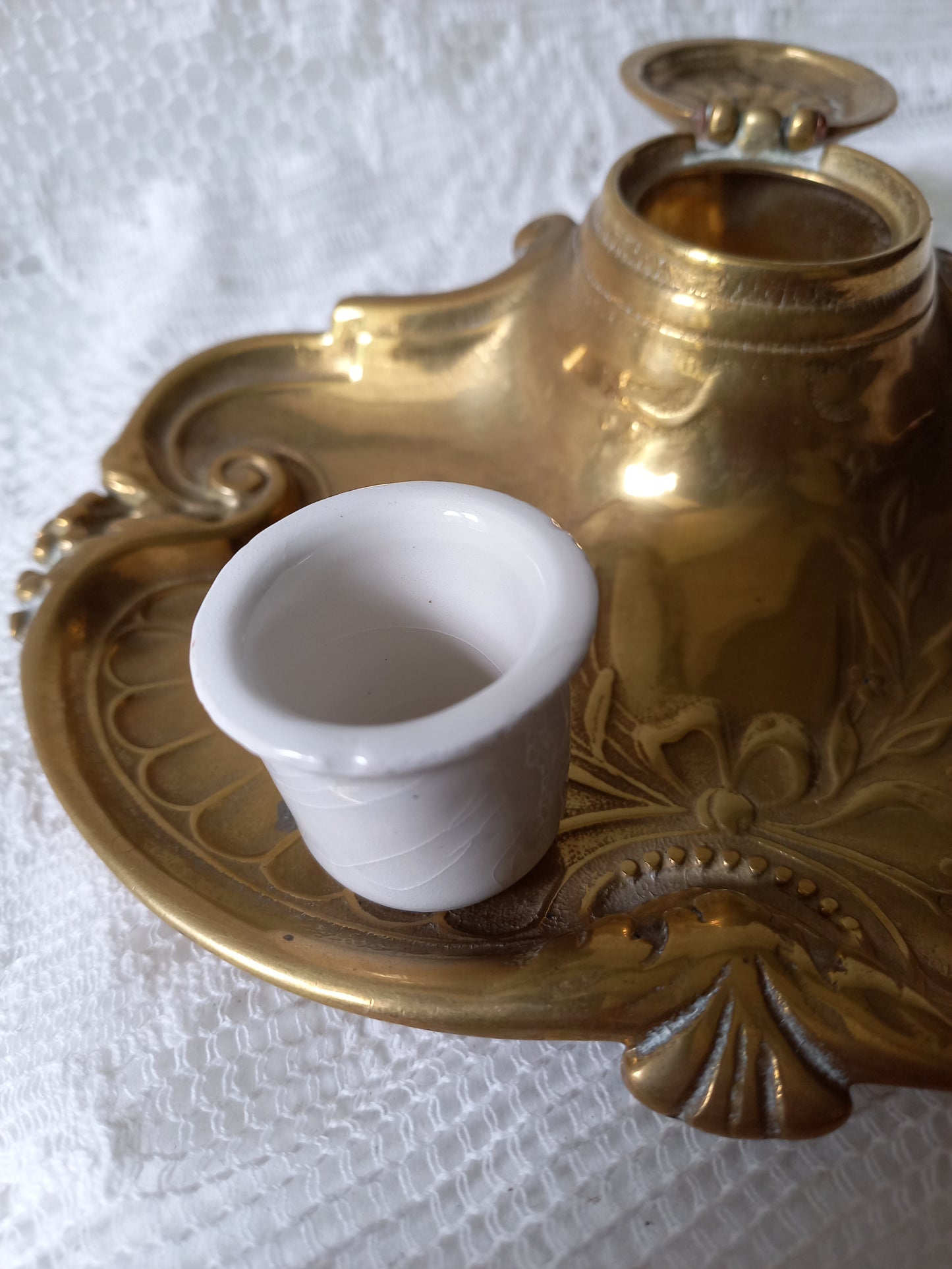 Decorative vintage brass inkwell with white porcelain ink cup