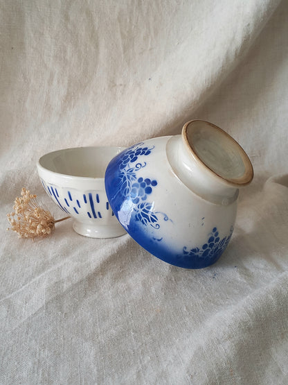 Ceramic bowls with blue floral design on a textured fabric background