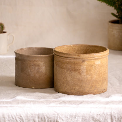 A pair of French antique tea-stained white to creamy brown ironstone crock pots or preserve pots.

In the past these small pots were quintessential pieces in French kitchens for storing jam, etc, and these days are still just as useful for items such as utensils.

Smaller pot was manufactured by Choisy le Roi, circa. late 1800s. The larger pot has no maker's mark - circa. late 1800s/early 1900s.