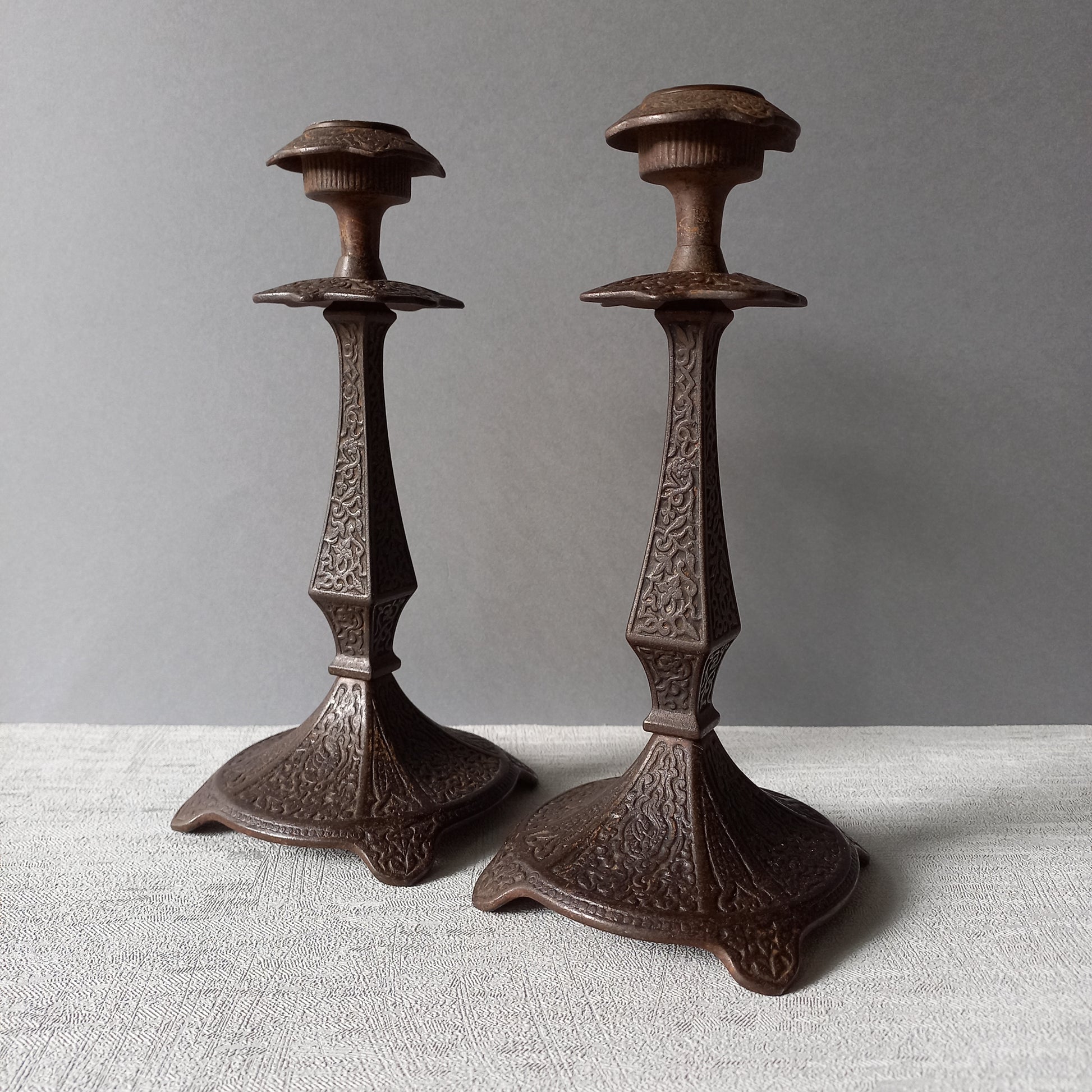 A pair of unusual French antique candle stick holders made from metal with intricate organic designs over their surfaces. There is a maker's mark underneath. Looking at their art nouveau styling we date these as approx late 1800s to early 1900s.
In summary, an interesting pair of candle stick holders that make eye catching home decor and would also be perfect for a vintage gift.