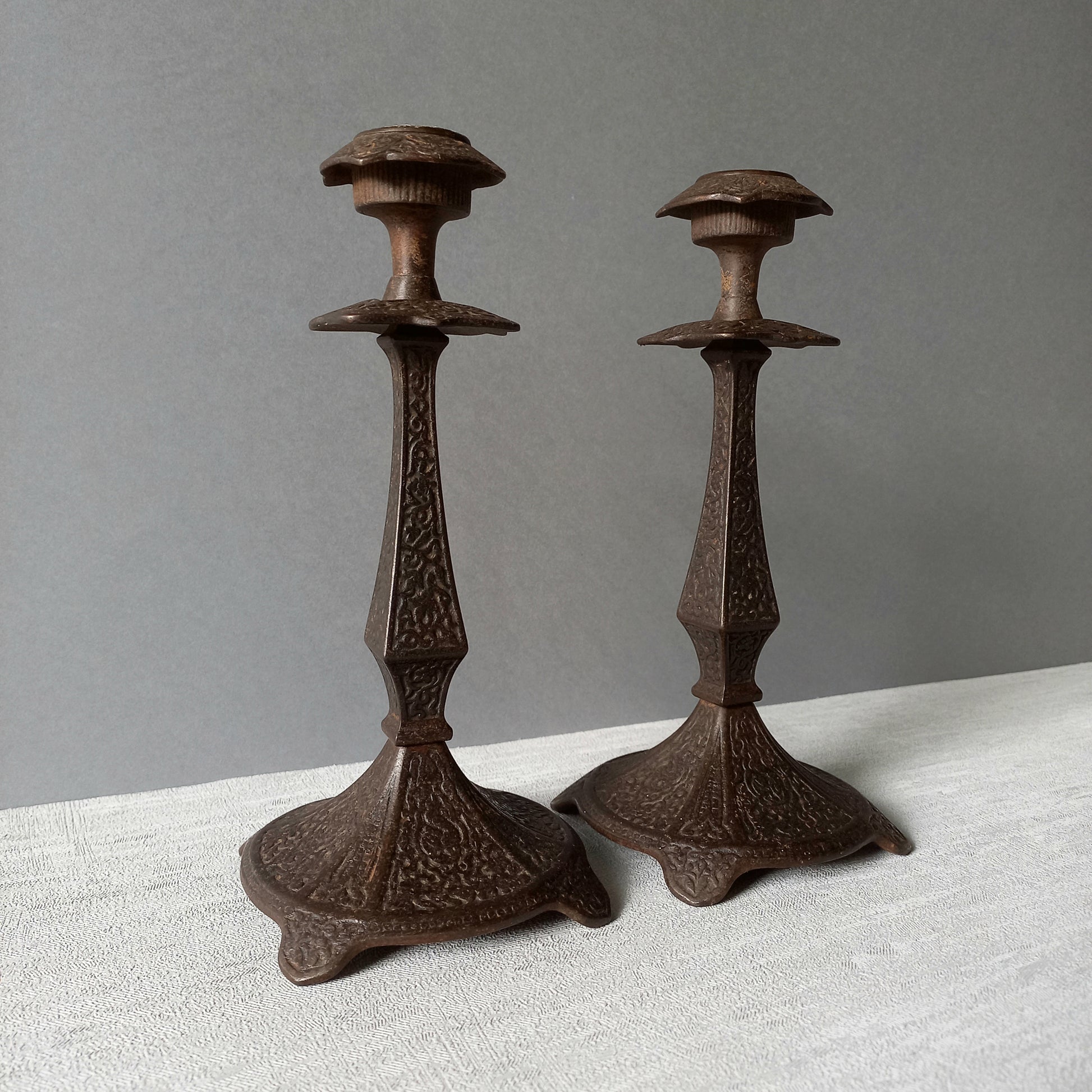 A pair of unusual French antique candle stick holders made from metal with intricate organic designs over their surfaces. There is a maker's mark underneath. Looking at their art nouveau styling we date these as approx late 1800s to early 1900s.
In summary, an interesting pair of candle stick holders that make eye catching home decor and would also be perfect for a vintage gift.