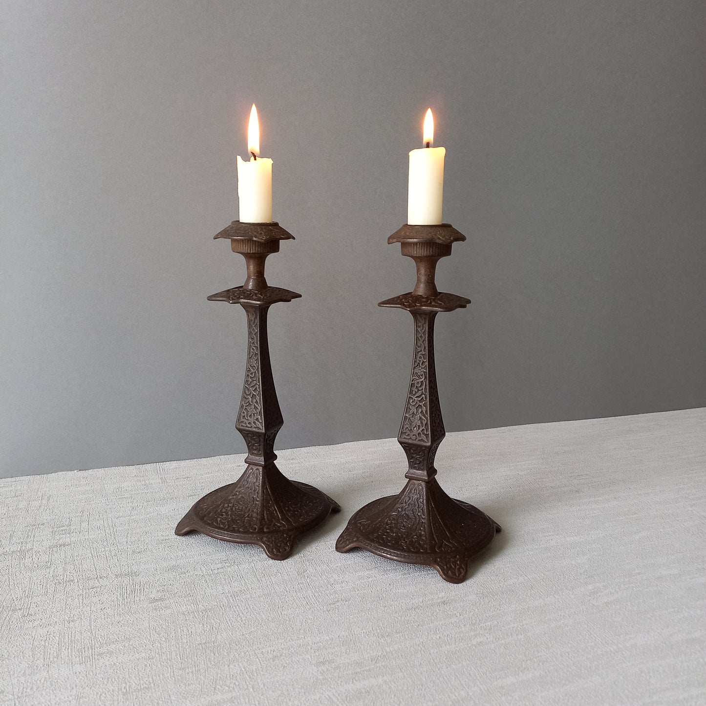 A pair of unusual French antique candle stick holders made from metal with intricate organic designs over their surfaces. There is a maker's mark underneath. Looking at their art nouveau styling we date these as approx late 1800s to early 1900s.
In summary, an interesting pair of candle stick holders that make eye catching home decor and would also be perfect for a vintage gift.