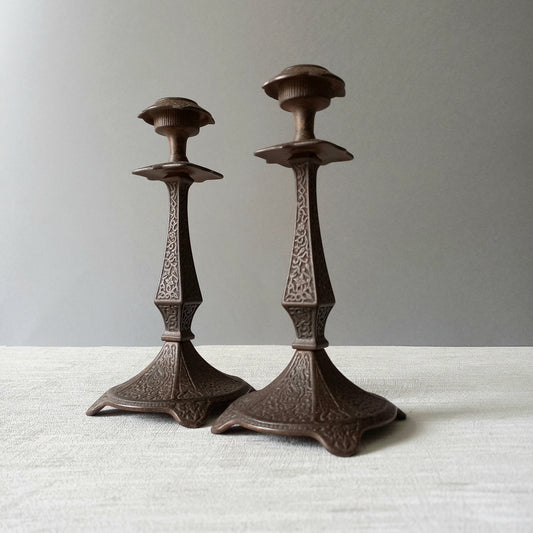 A pair of unusual French antique candle stick holders made from metal with intricate organic designs over their surfaces. There is a maker's mark underneath. Looking at their art nouveau styling we date these as approx late 1800s to early 1900s.
In summary, an interesting pair of candle stick holders that make eye catching home decor and would also be perfect for a vintage gift.