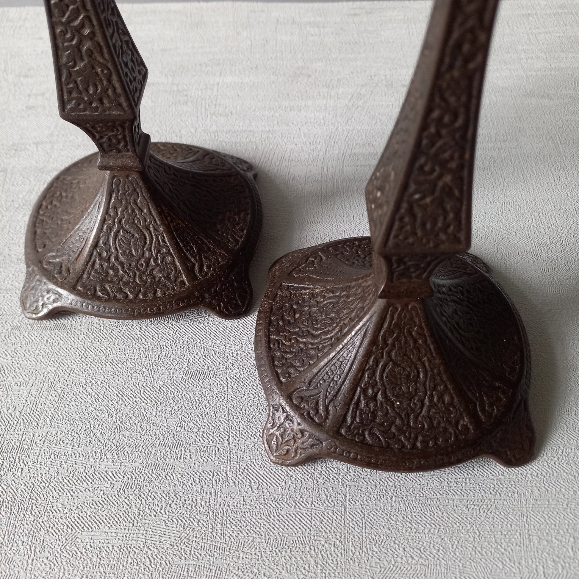 A pair of unusual French antique candle stick holders made from metal with intricate organic designs over their surfaces. There is a maker's mark underneath. Looking at their art nouveau styling we date these as approx late 1800s to early 1900s.
In summary, an interesting pair of candle stick holders that make eye catching home decor and would also be perfect for a vintage gift.