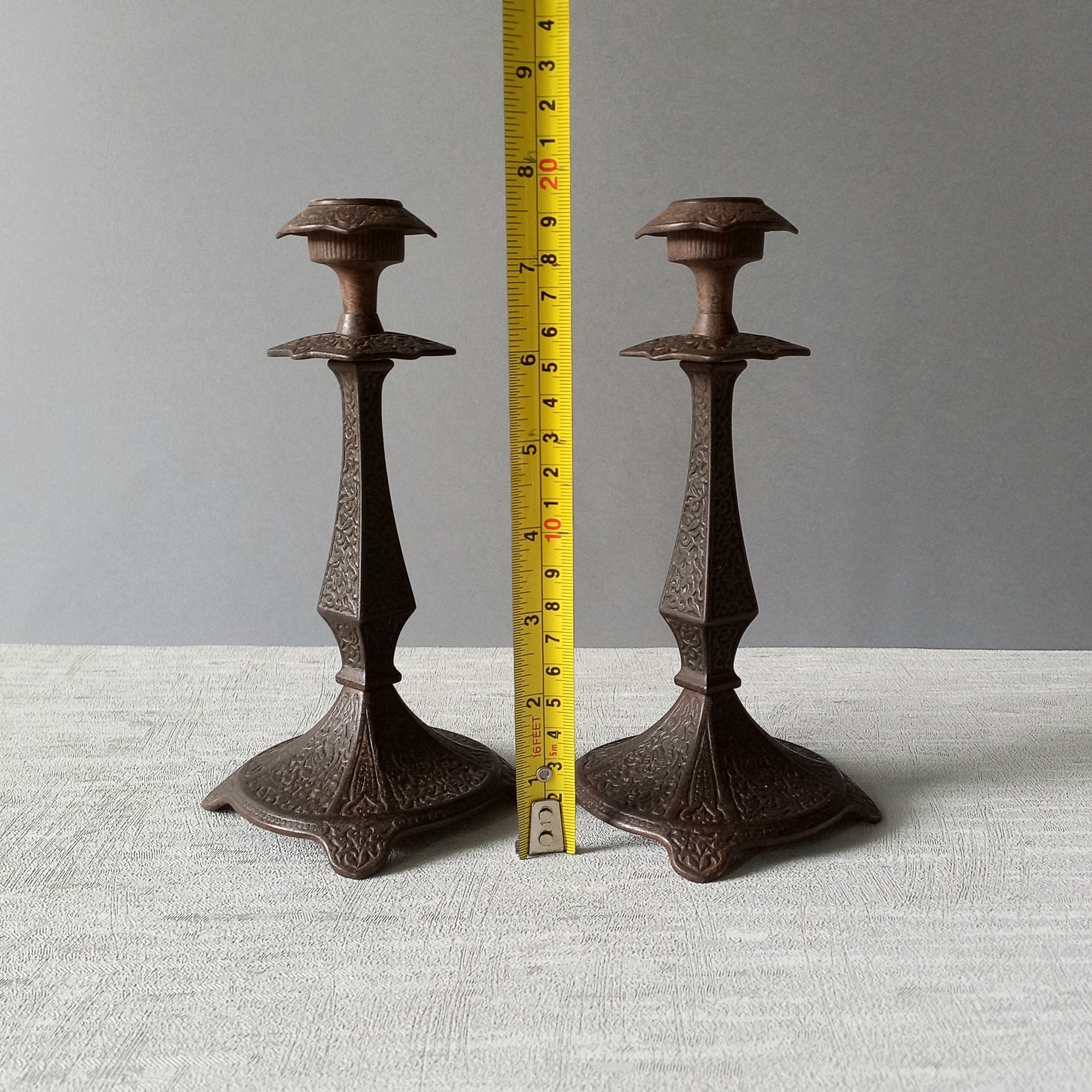 A pair of unusual French antique candle stick holders made from metal with intricate organic designs over their surfaces. There is a maker's mark underneath. Looking at their art nouveau styling we date these as approx late 1800s to early 1900s.
In summary, an interesting pair of candle stick holders that make eye catching home decor and would also be perfect for a vintage gift.