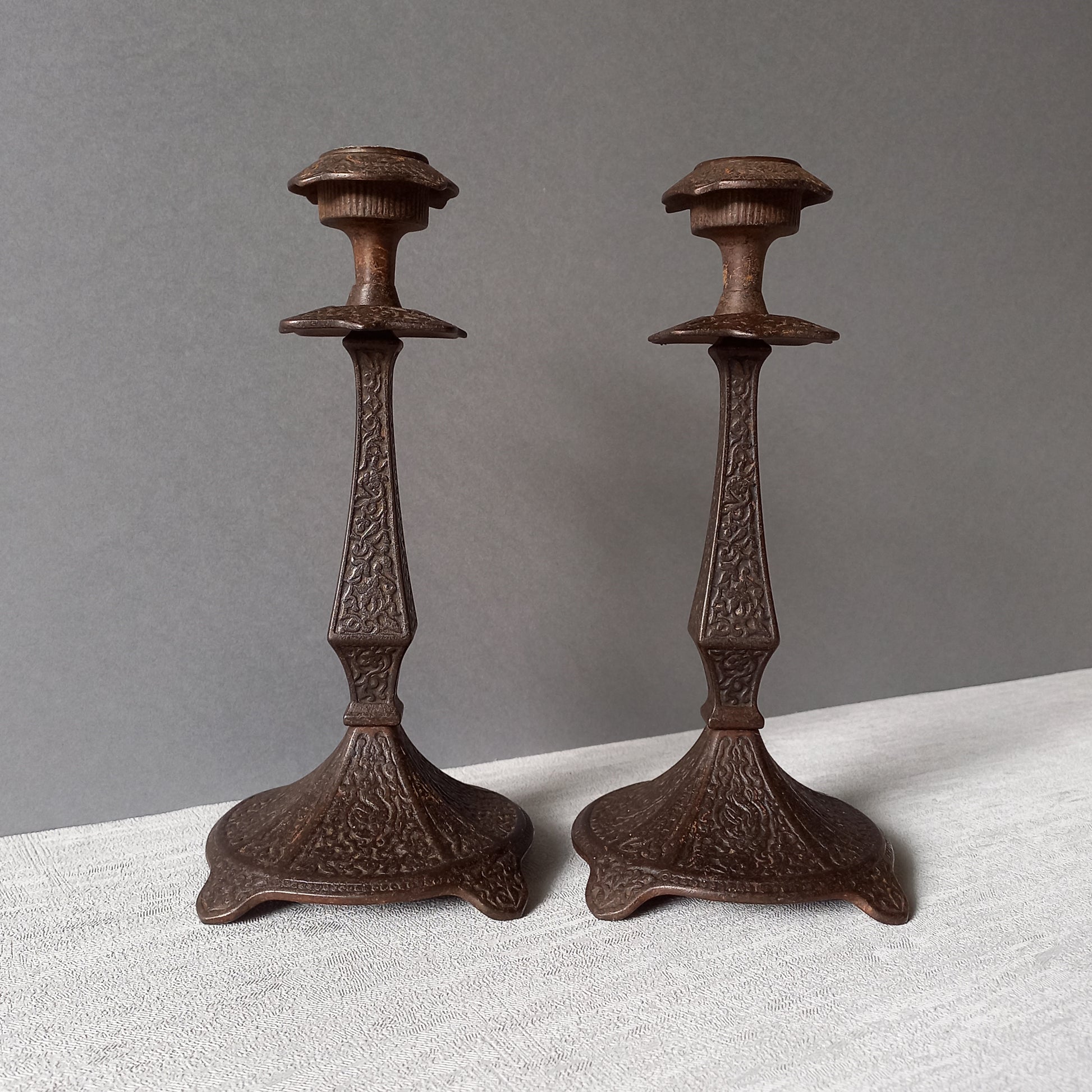 A pair of unusual French antique candle stick holders made from metal with intricate organic designs over their surfaces. There is a maker's mark underneath. Looking at their art nouveau styling we date these as approx late 1800s to early 1900s.
In summary, an interesting pair of candle stick holders that make eye catching home decor and would also be perfect for a vintage gift.