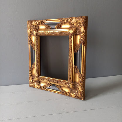 Stunning vintage frame for a painting or photo with ornate decoration in an antique style from France. This frame is a solid and heavy piece, seems to be wooden although we also think there might be some plaster so we are calling it a frame made of mixed materials.