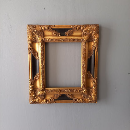 Stunning vintage frame for a painting or photo with ornate decoration in an antique style from France. This frame is a solid and heavy piece, seems to be wooden although we also think there might be some plaster so we are calling it a frame made of mixed materials.