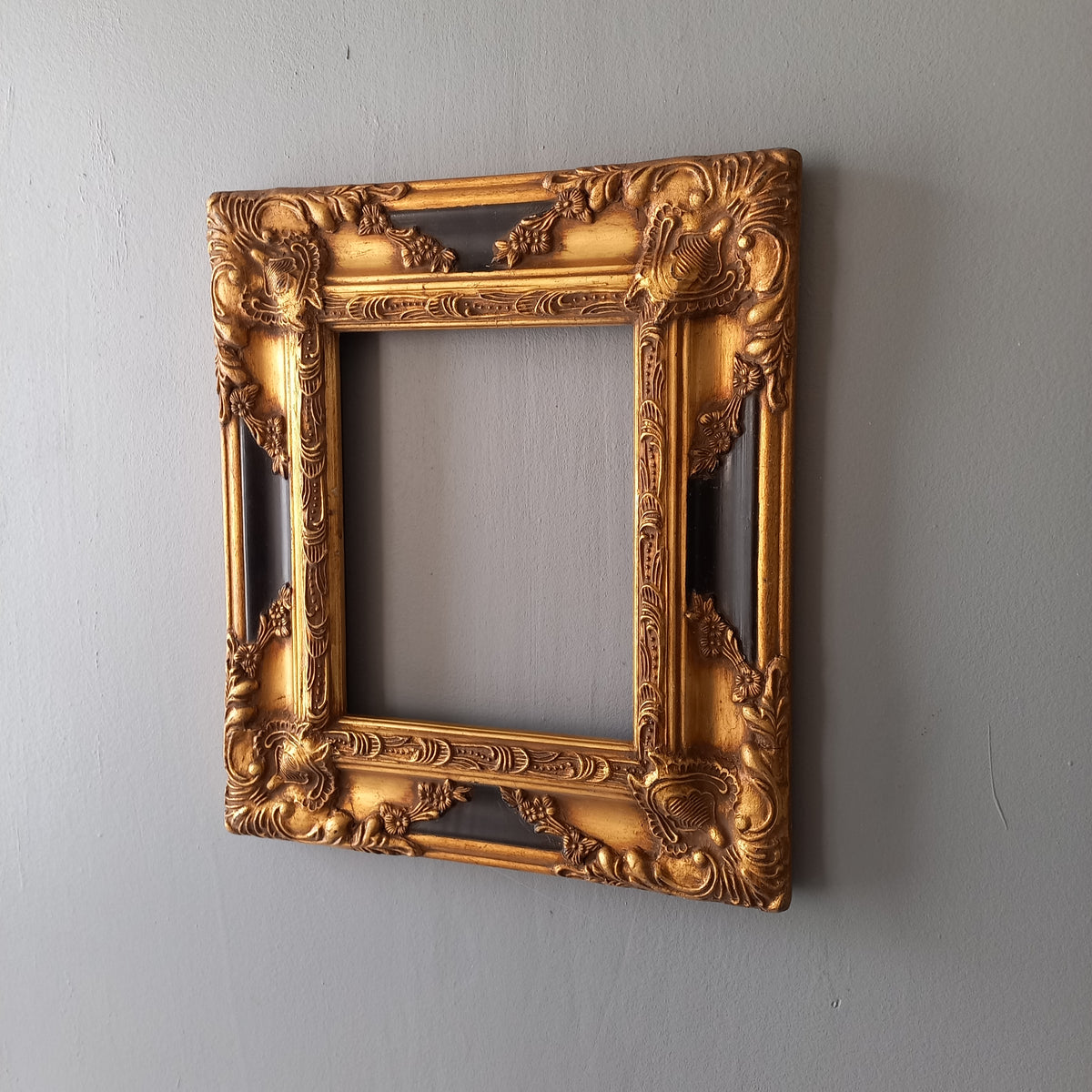 Stunning vintage frame for a painting or photo with ornate decoration in an antique style from France. This frame is a solid and heavy piece, seems to be wooden although we also think there might be some plaster so we are calling it a frame made of mixed materials.