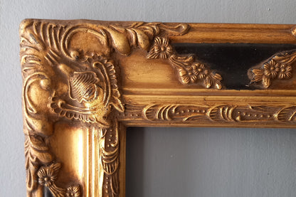 Stunning vintage frame for a painting or photo with ornate decoration in an antique style from France. This frame is a solid and heavy piece, seems to be wooden although we also think there might be some plaster so we are calling it a frame made of mixed materials.