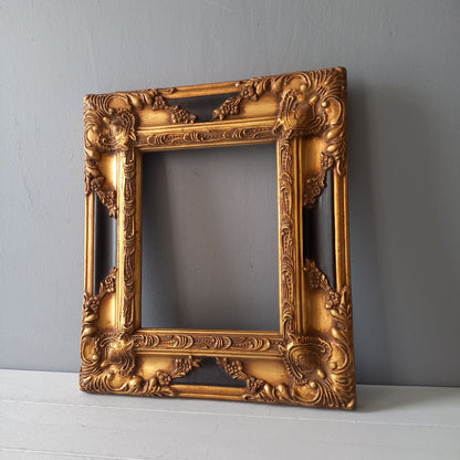 Stunning vintage frame for a painting or photo with ornate decoration in an antique style from France. This frame is a solid and heavy piece, seems to be wooden although we also think there might be some plaster so we are calling it a frame made of mixed materials.