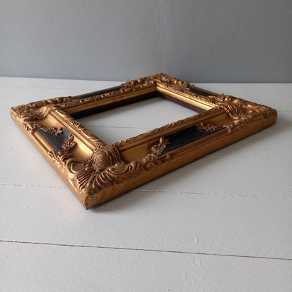 Stunning vintage frame for a painting or photo with ornate decoration in an antique style from France. This frame is a solid and heavy piece, seems to be wooden although we also think there might be some plaster so we are calling it a frame made of mixed materials.