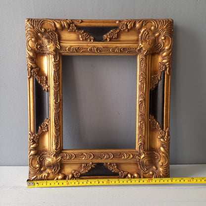 Stunning vintage frame for a painting or photo with ornate decoration in an antique style from France. This frame is a solid and heavy piece, seems to be wooden although we also think there might be some plaster so we are calling it a frame made of mixed materials.