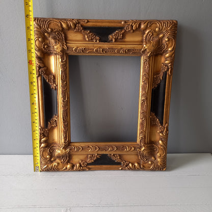 Stunning vintage frame for a painting or photo with ornate decoration in an antique style from France. This frame is a solid and heavy piece, seems to be wooden although we also think there might be some plaster so we are calling it a frame made of mixed materials.