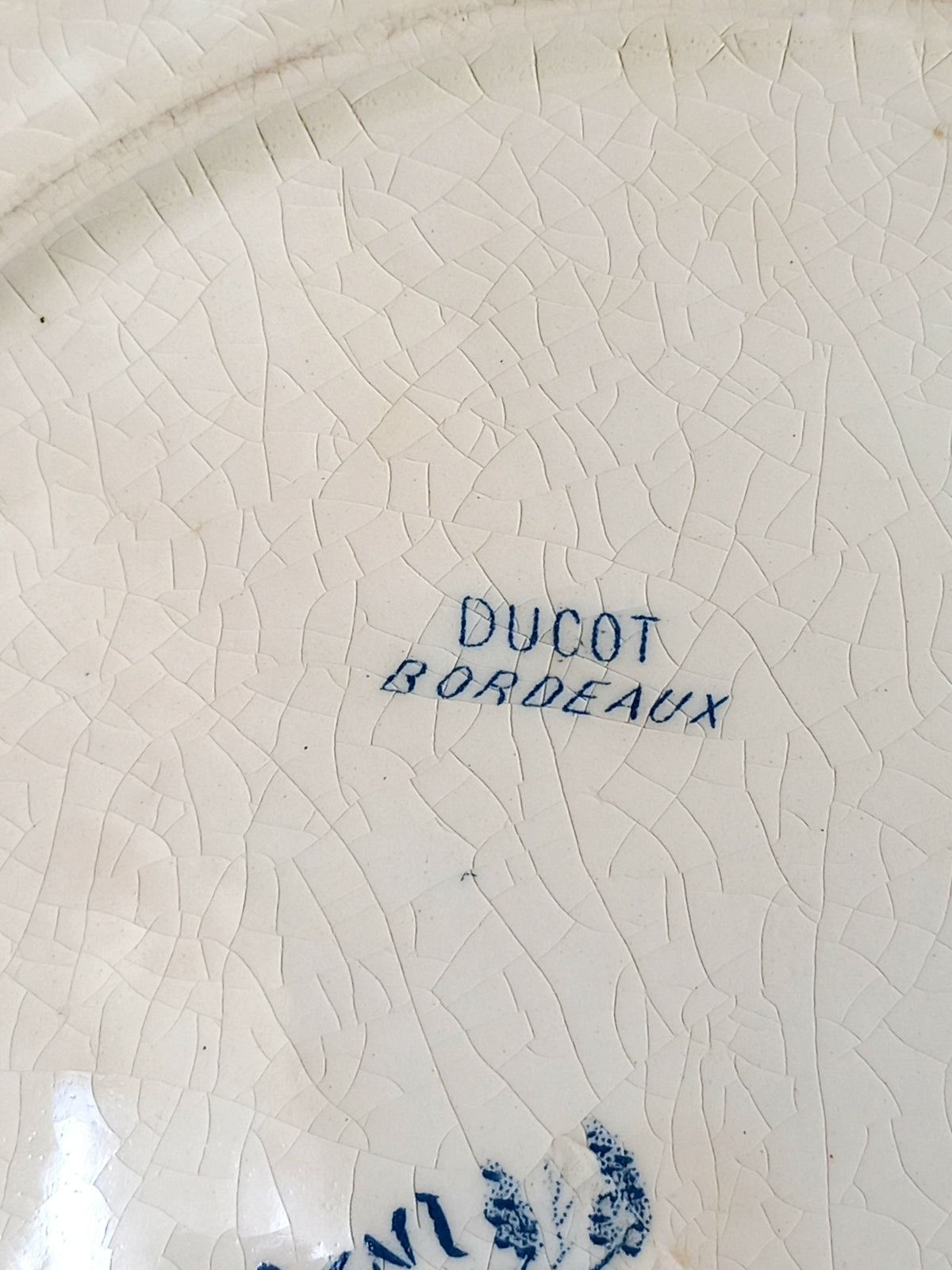Rear of a French antique ironstone octagonal plate with the monogram/initial 'B'.