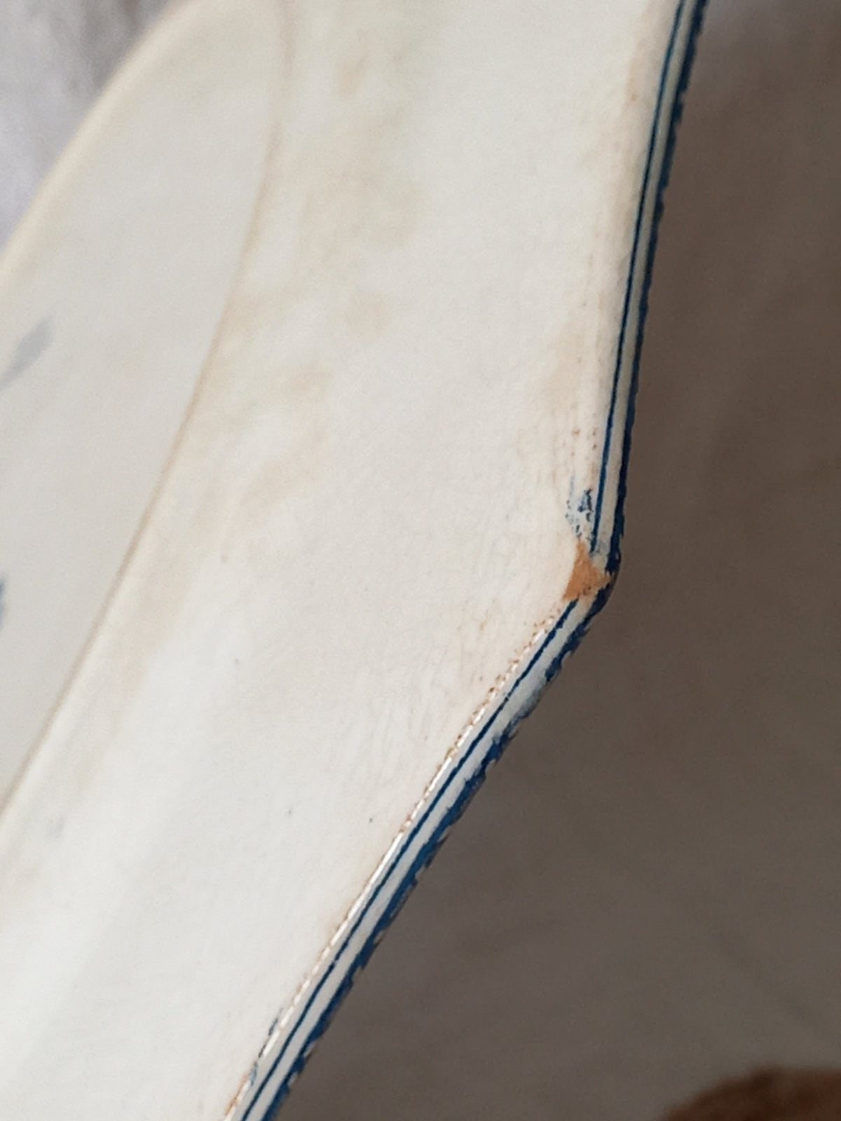 Detail of the corner of a French antique ironstone octagonal plate with the monogram/initial 'B'.