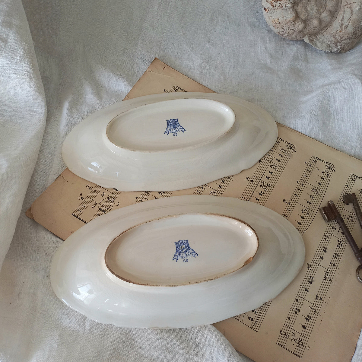 A beautiful pair of French vintage white ironstone side plates or raviers with attractive blue designs. These particular pieces were manufactured by Gien.