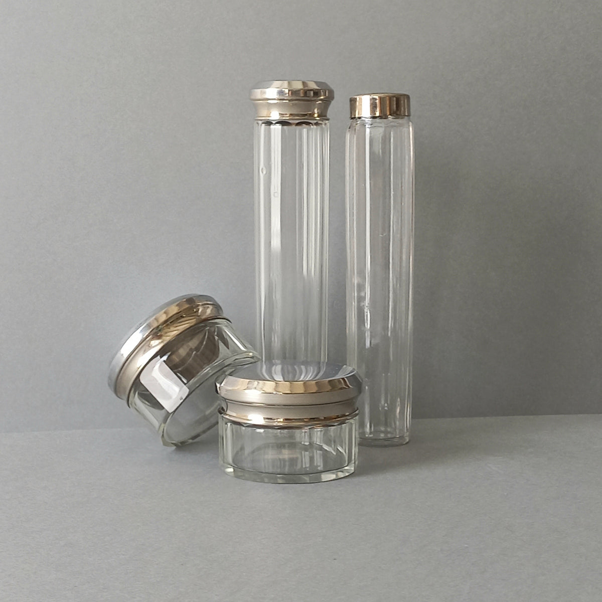 A set of 4 small French vintage decorative glass perfume/scent bottles/make-up containers that will make pleasing decorative pieces in your interior.