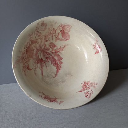 A large French vintage ironstone bowl with beautiful deep pink floral pattern on a creamy white base colour. Over the years this old bowl has aged nicely with crazing, tea-staining, and the odd little imperfections that show this as an authentic antique piece.

There is a maker's mark on the base. Circa. late 1800s/early 1900s.