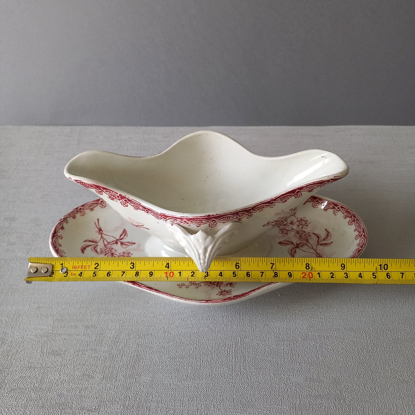 A French antique ironstone gravy boat with a pretty pink floral transfer pattern, a heavy and quality piece manufactured by St. Amand,circa. early 20th century.