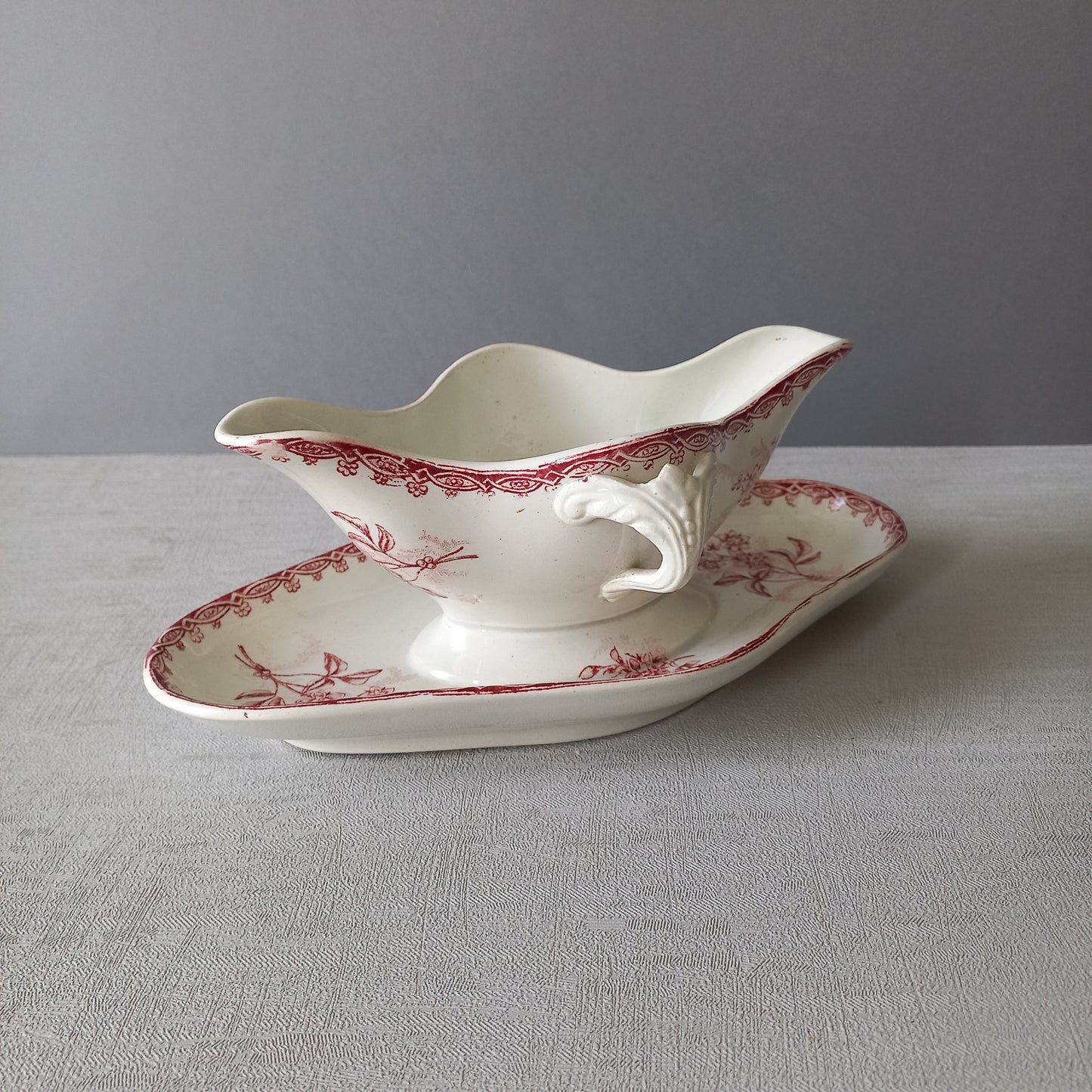 A French antique ironstone gravy boat with a pretty pink floral transfer pattern, a heavy and quality piece manufactured by St. Amand,circa. early 20th century.