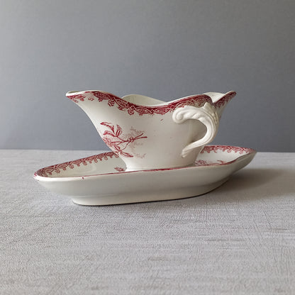 A French antique ironstone gravy boat with a pretty pink floral transfer pattern, a heavy and quality piece manufactured by St. Amand,circa. early 20th century.