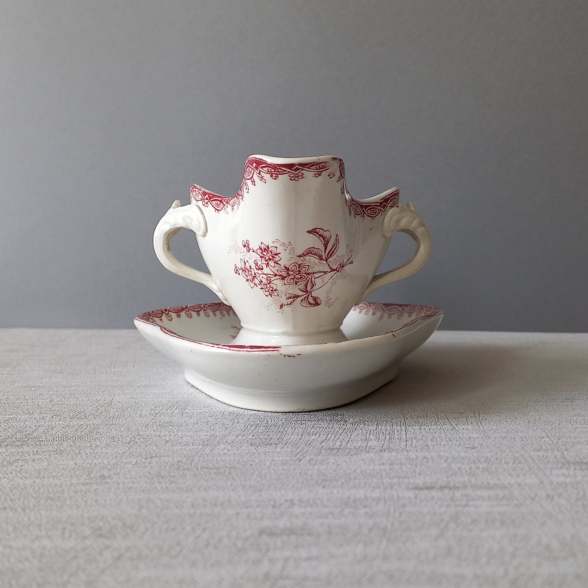 A French antique ironstone gravy boat with a pretty pink floral transfer pattern, a heavy and quality piece manufactured by St. Amand,circa. early 20th century.