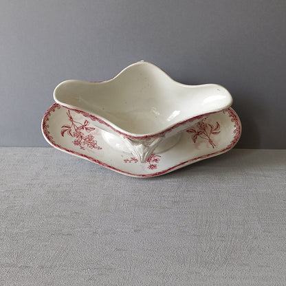 A French antique ironstone gravy boat with a pretty pink floral transfer pattern, a heavy and quality piece manufactured by St. Amand,circa. early 20th century.