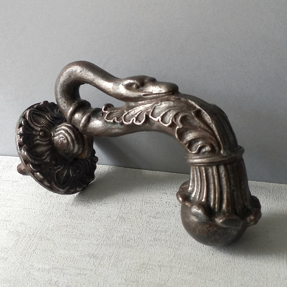 A stunning and large antique cast iron decorative door knocker with an elegant swan's neck and head, a very heavy and original antique piece purchased in south west France. 