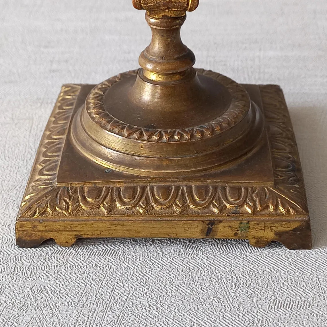 Decorative gold candle holder on a wooden surface