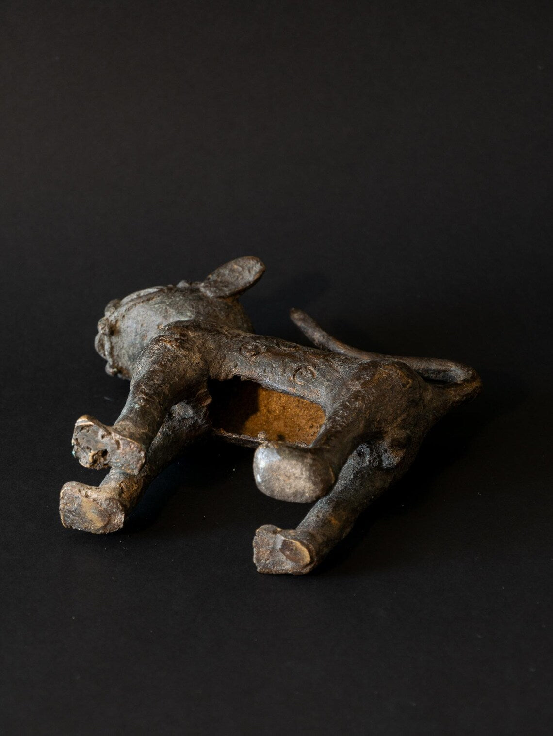 Metallic figurine of a panther on a black background