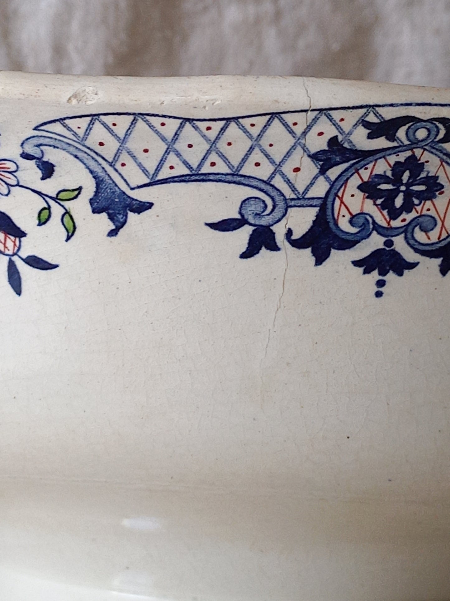 Close-up of a large French antique decorative footed bowl with a stunning floral pattern in a decorative setting .