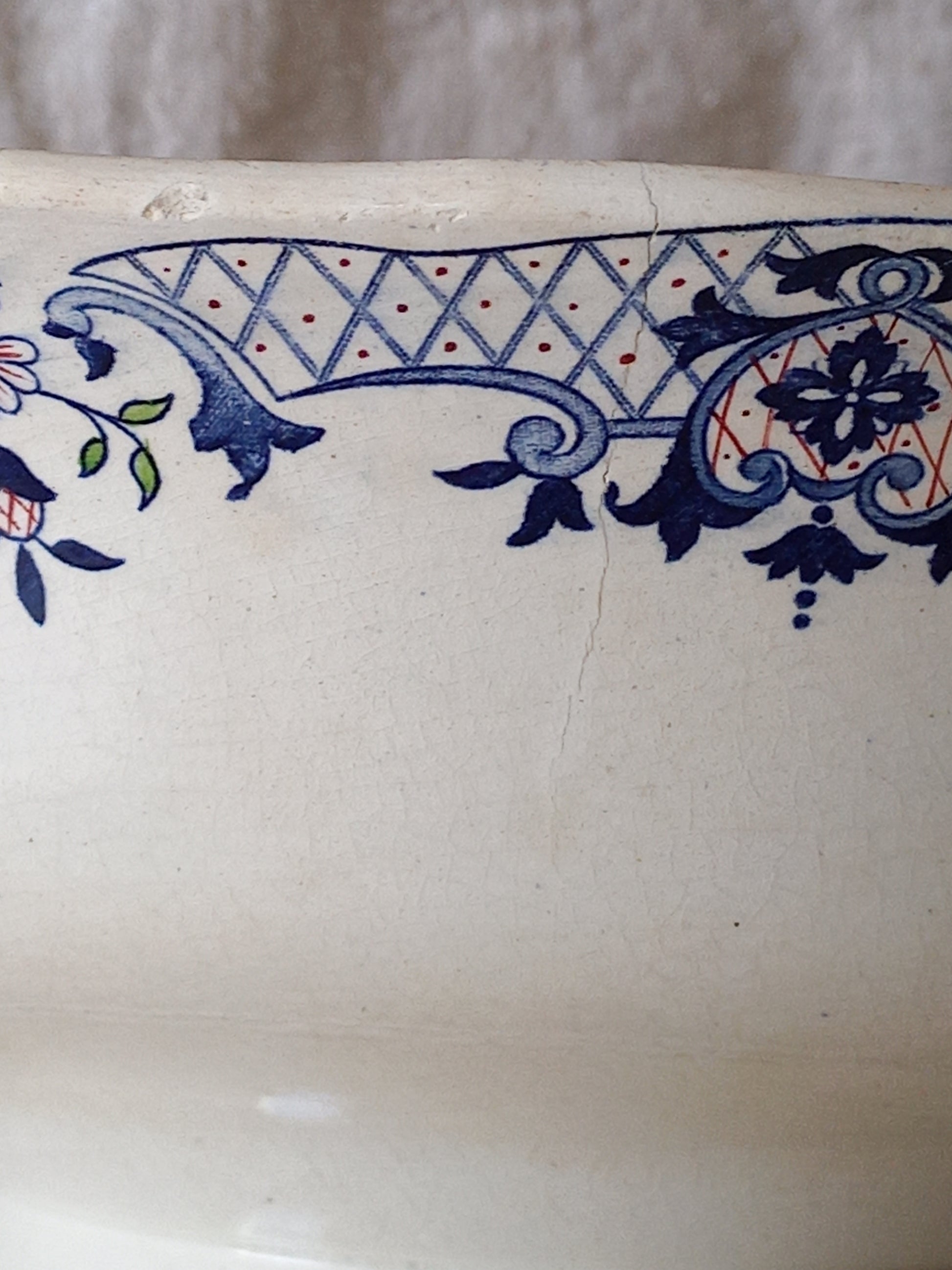 Close-up of a large French antique decorative footed bowl with a stunning floral pattern in a decorative setting .