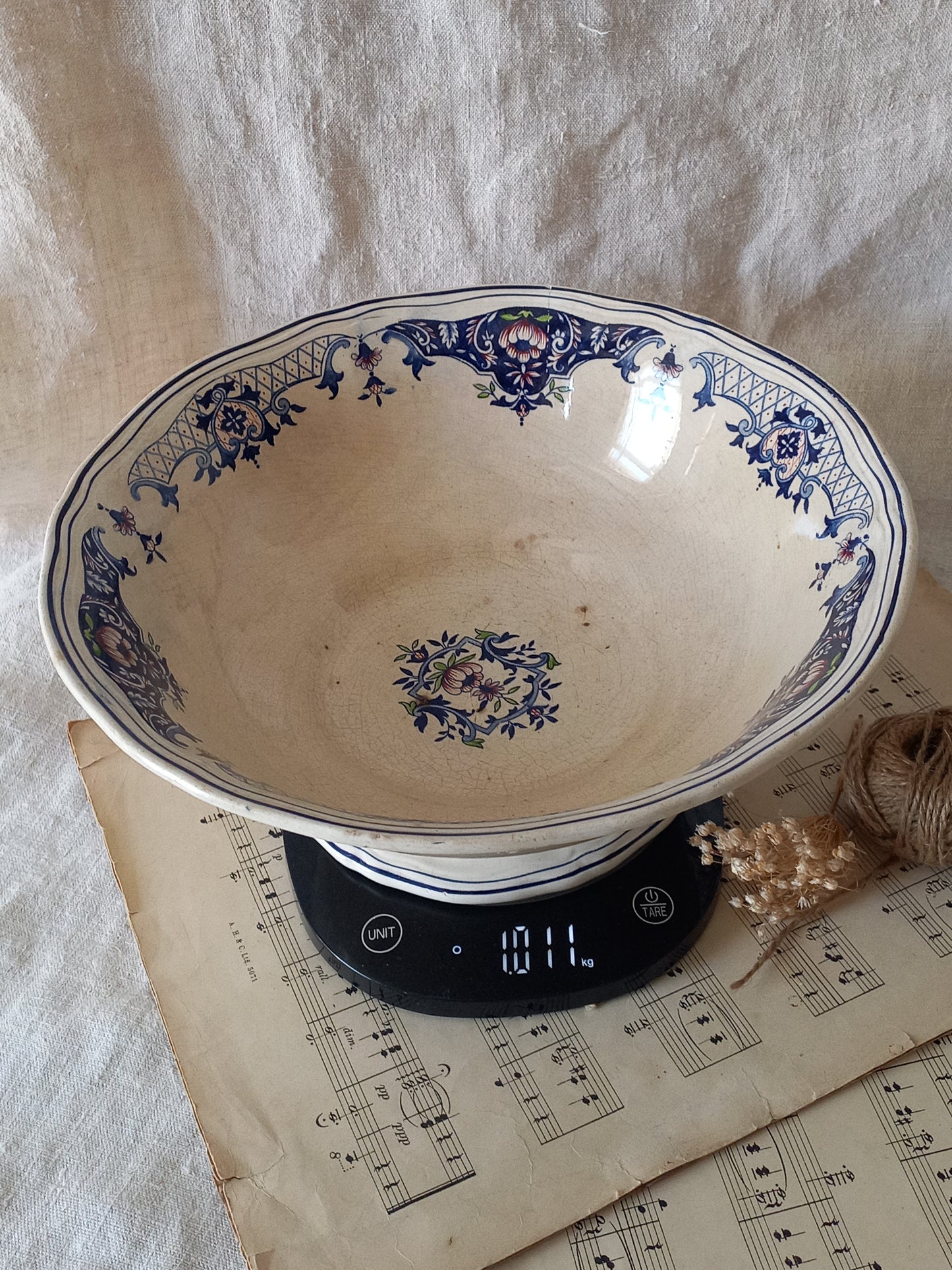 Large French antique decorative footed bowl with a stunning floral pattern in a decorative setting  on digital scales for reference.