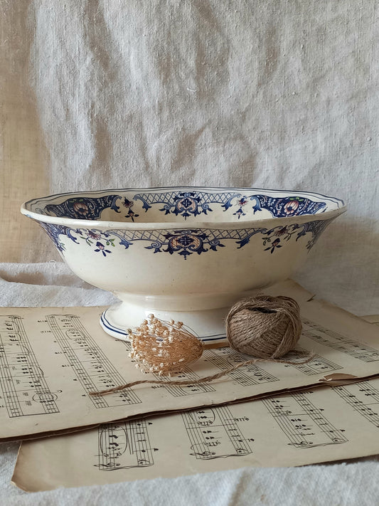 Large French antique decorative footed bowl with a stunning floral pattern in a decorative setting.