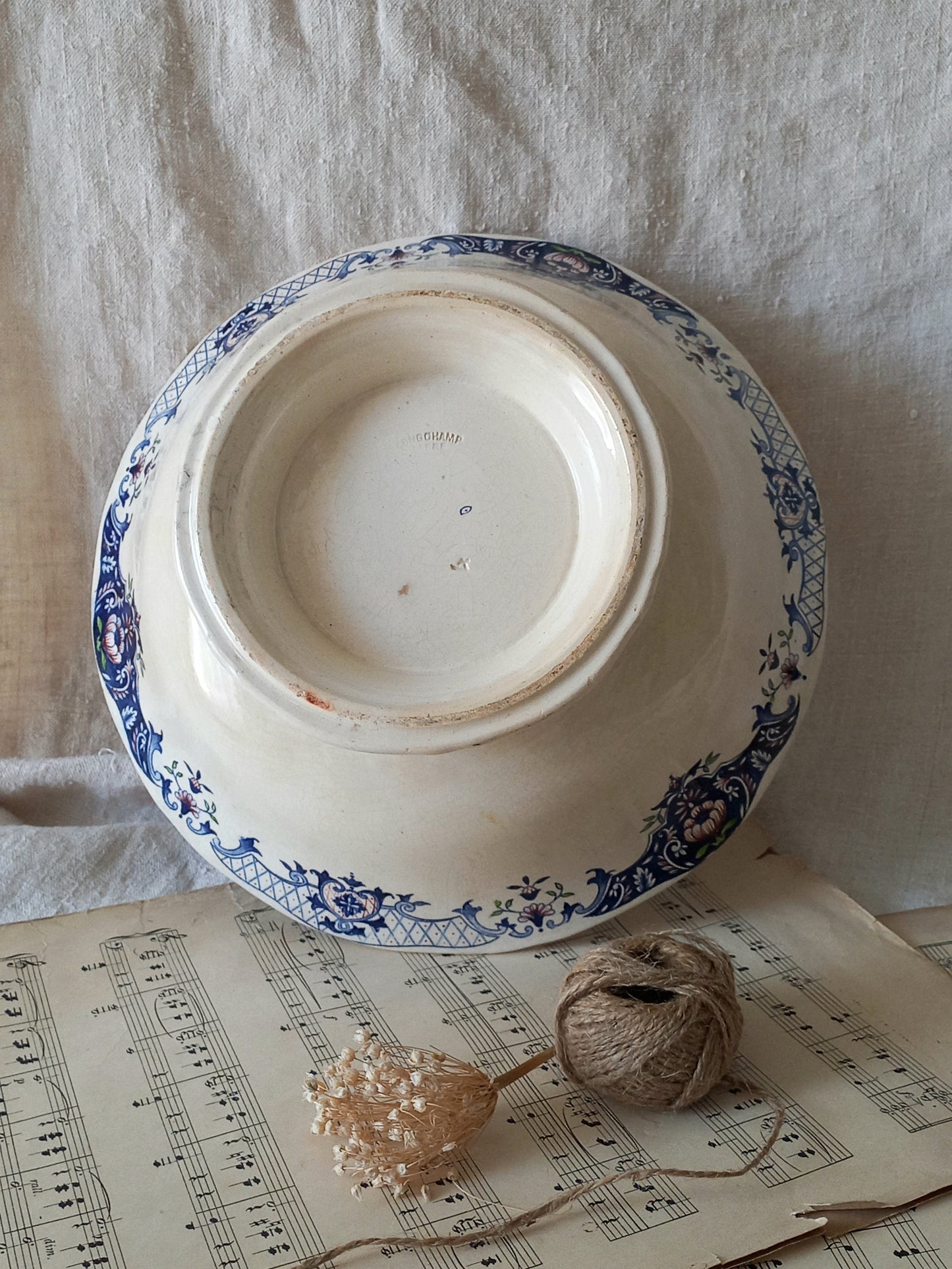 Large French antique decorative footed bowl with a stunning floral pattern in a decorative setting .