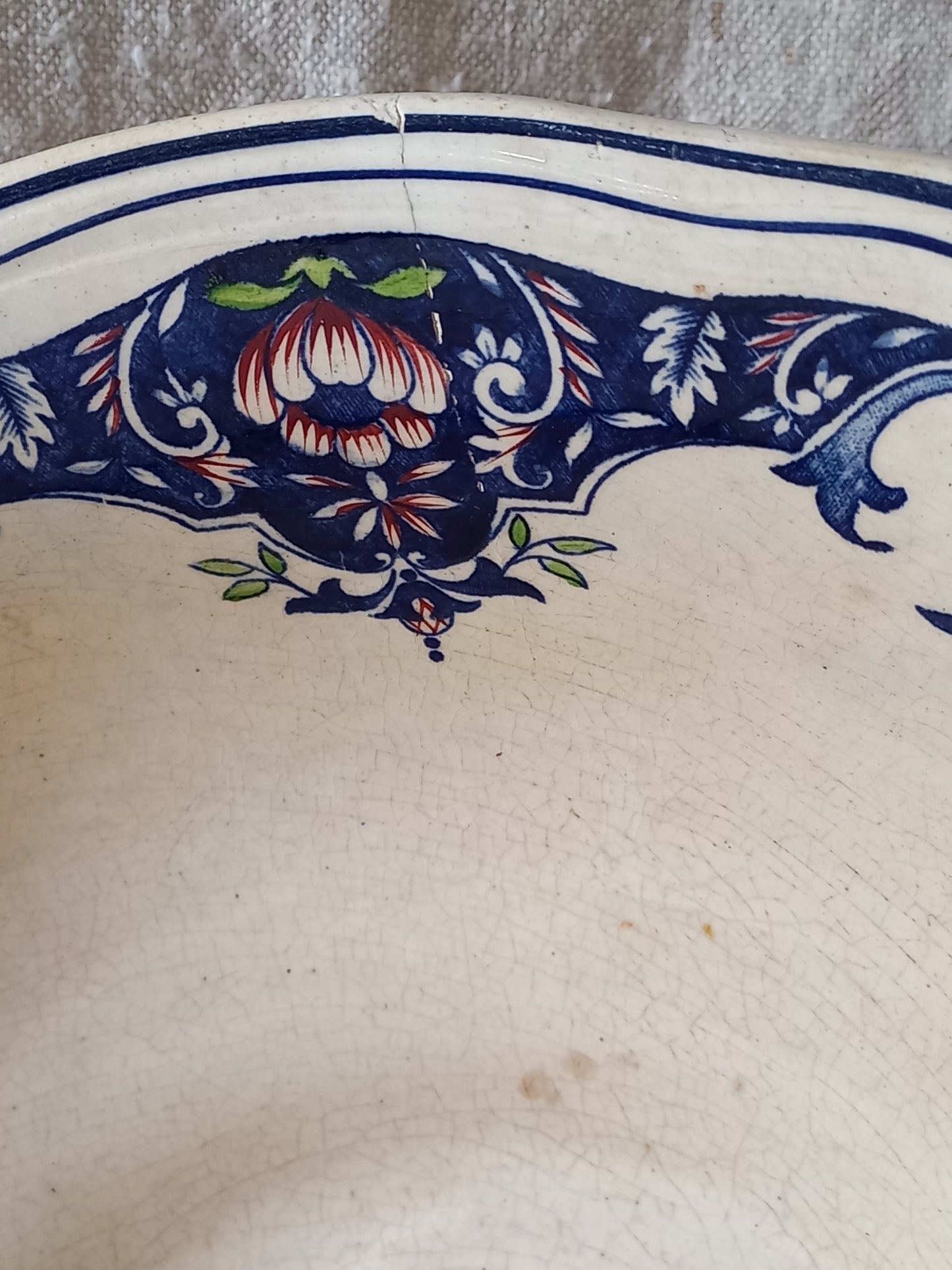 Close-up of a large French antique decorative footed bowl with a stunning floral pattern in a decorative setting.