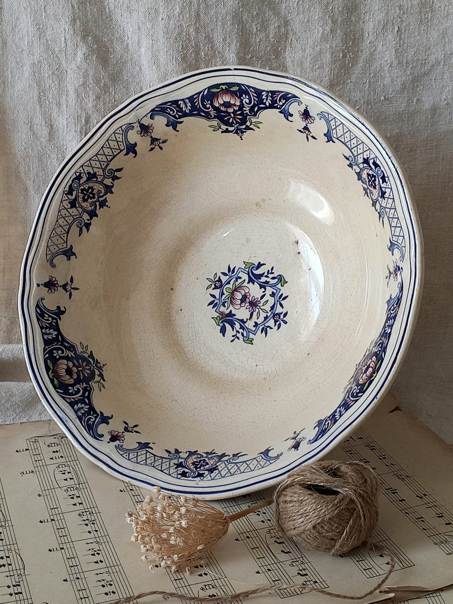 Large French antique decorative footed bowl with a stunning floral pattern in a decorative setting.
