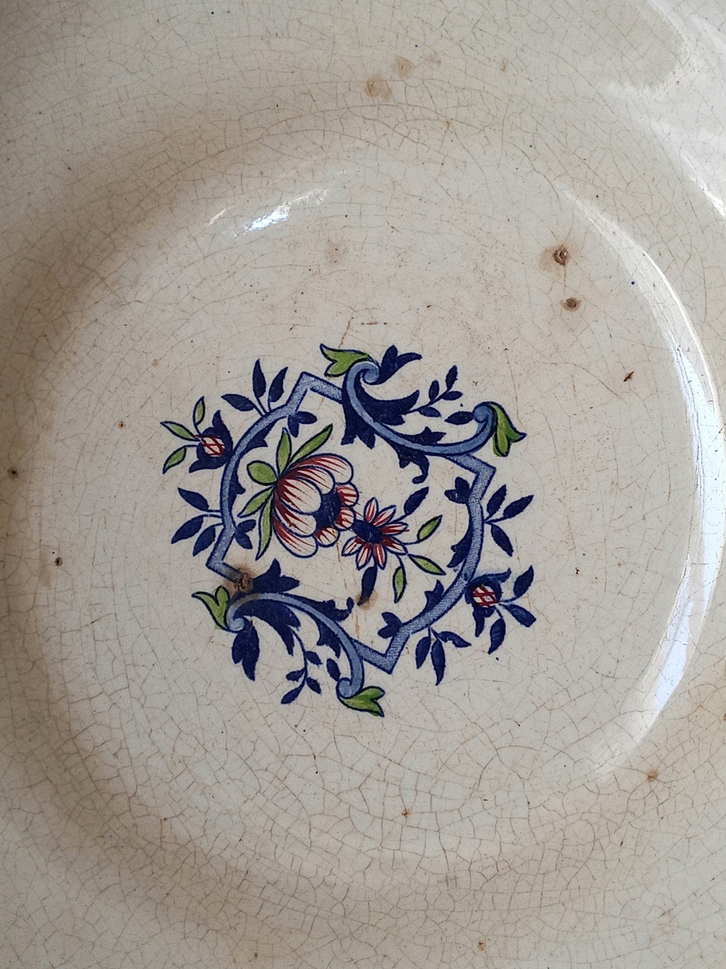 Close-up of a large French antique decorative footed bowl with a stunning floral pattern in a decorative setting .