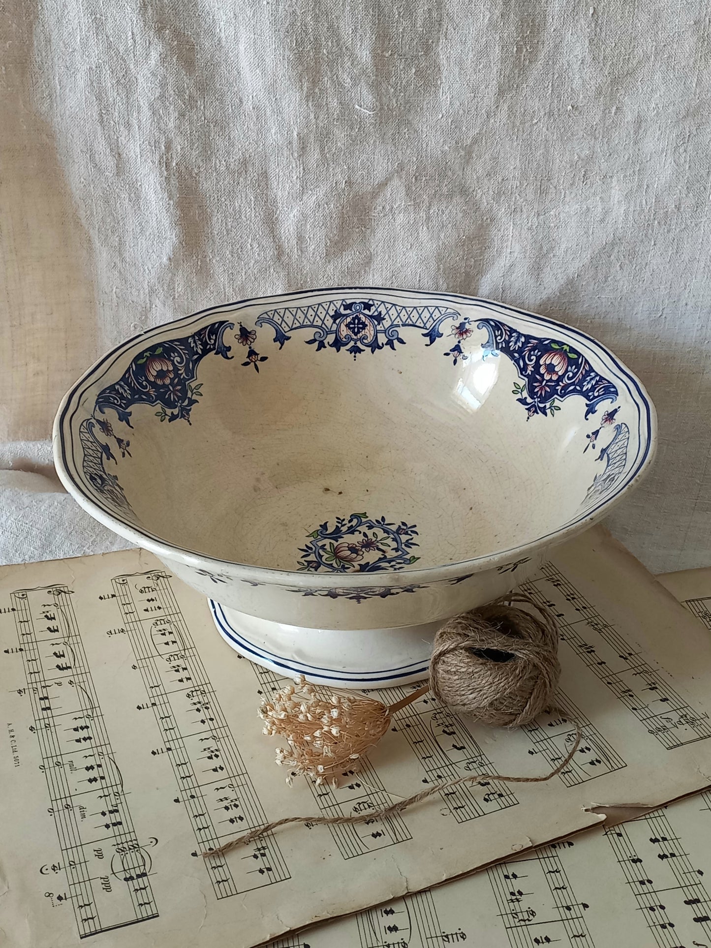 Large French antique decorative footed bowl with a stunning floral pattern in a decorative setting.