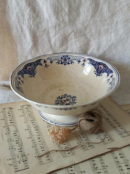 Large French antique decorative footed bowl with a stunning floral pattern in a decorative setting.