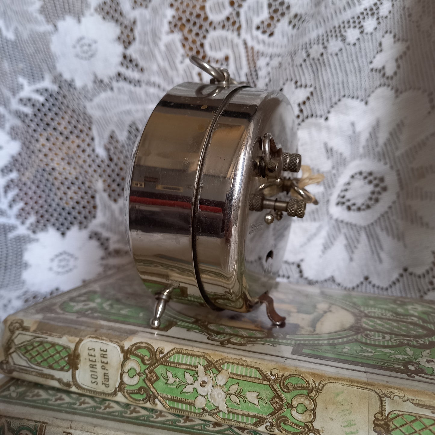 Small vintage mechanical alarm clock by French company Jaz with silver colored, chrome case