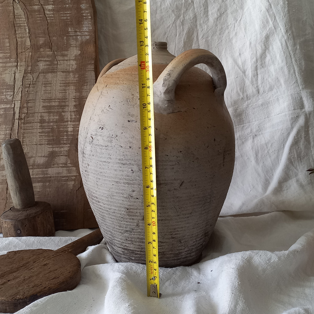 A large vintage/antique hand-made stoneware jar once used to store oil - with its wonderful earthy tones these days it will make an eye-catching piece of decor full of rustic charm that offers many decorative possibilities to any interior, particularly those of a country, rustic or farmhouse nature.