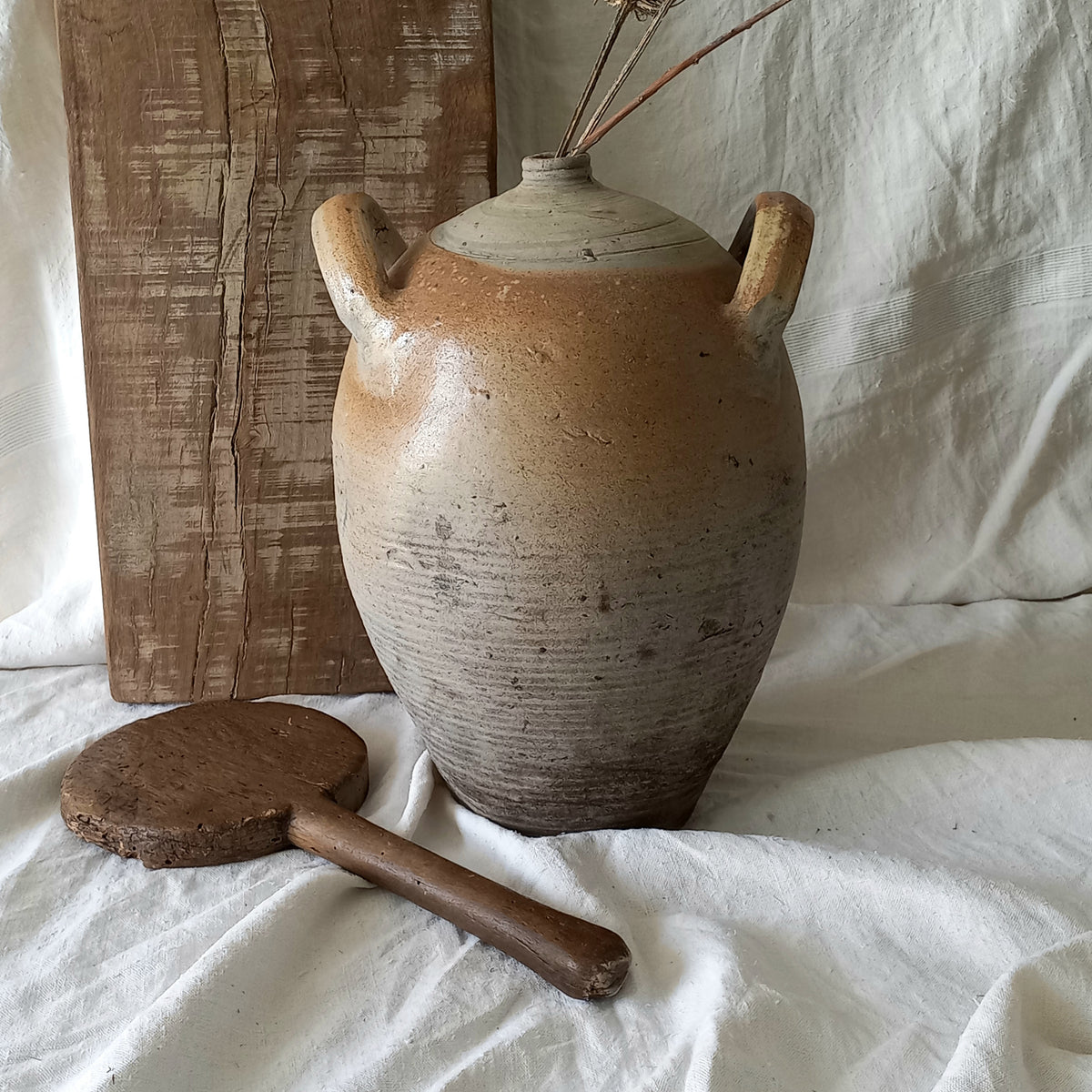 A large vintage/antique hand-made stoneware jar once used to store oil - with its wonderful earthy tones these days it will make an eye-catching piece of decor full of rustic charm that offers many decorative possibilities to any interior, particularly those of a country, rustic or farmhouse nature.