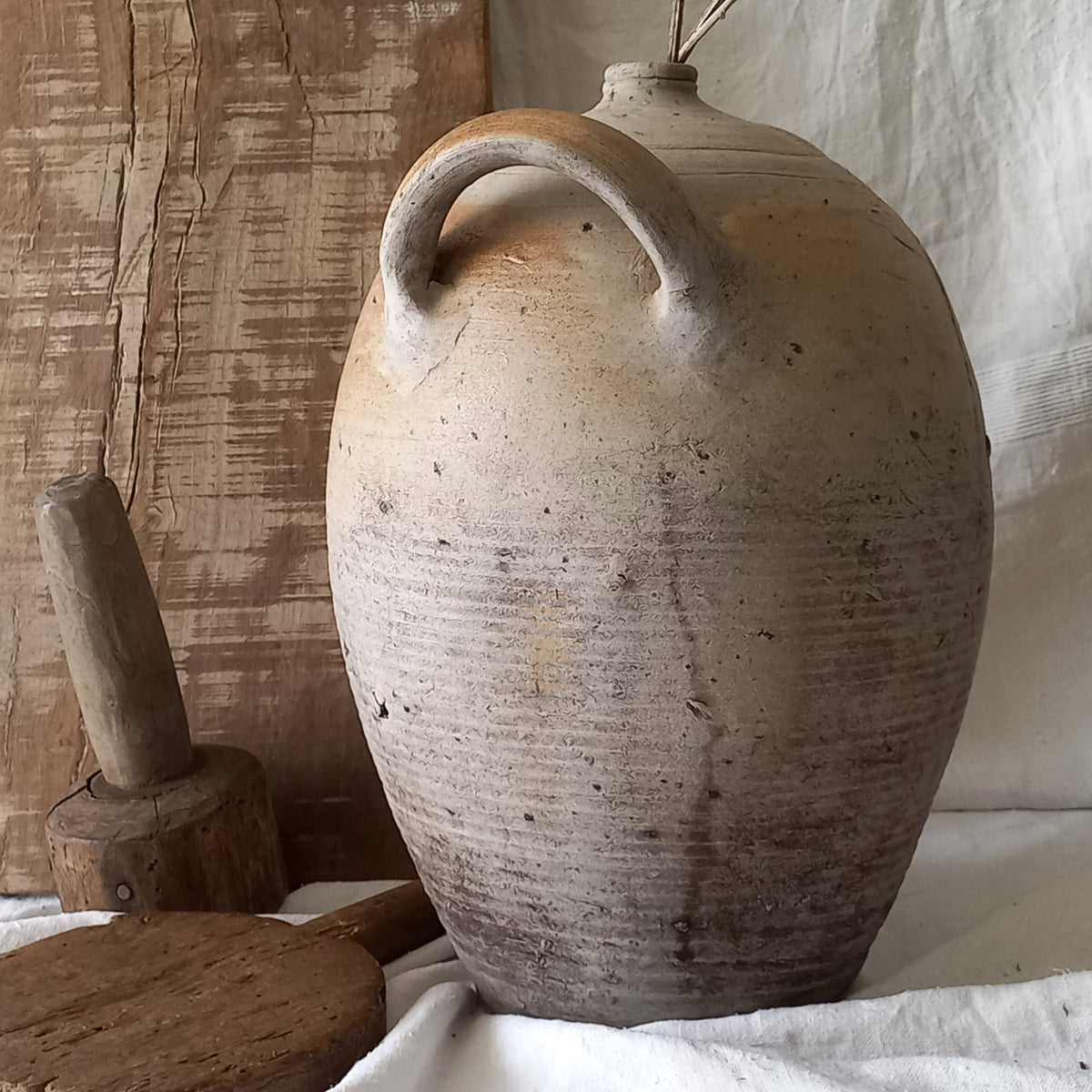 A large vintage/antique hand-made stoneware jar once used to store oil - with its wonderful earthy tones these days it will make an eye-catching piece of decor full of rustic charm that offers many decorative possibilities to any interior, particularly those of a country, rustic or farmhouse nature.