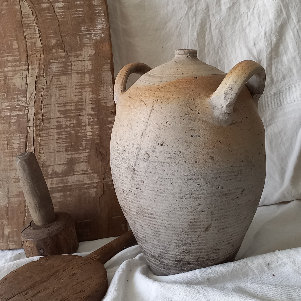 A large vintage/antique hand-made stoneware jar once used to store oil - with its wonderful earthy tones these days it will make an eye-catching piece of decor full of rustic charm that offers many decorative possibilities to any interior, particularly those of a country, rustic or farmhouse nature.